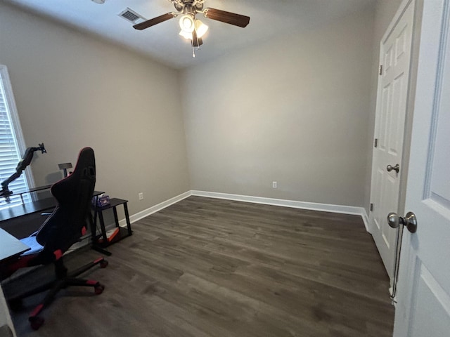 office with a ceiling fan, dark wood-style flooring, visible vents, and baseboards