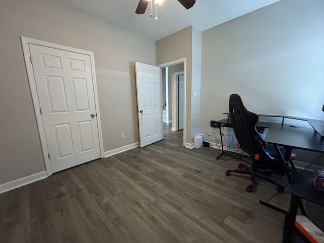 office space with dark wood-style flooring, a ceiling fan, and baseboards