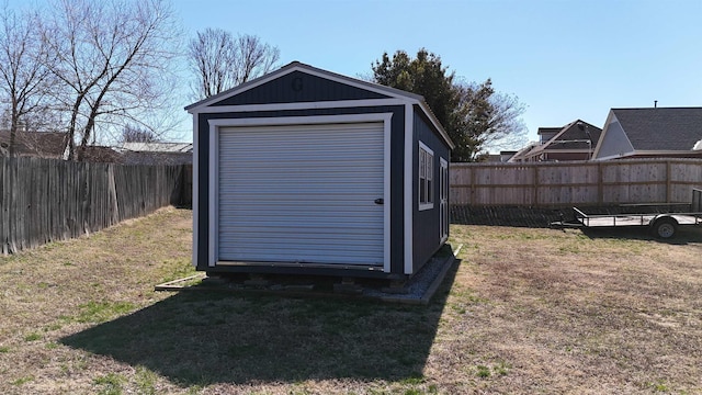 view of outdoor structure featuring an outbuilding and a fenced backyard