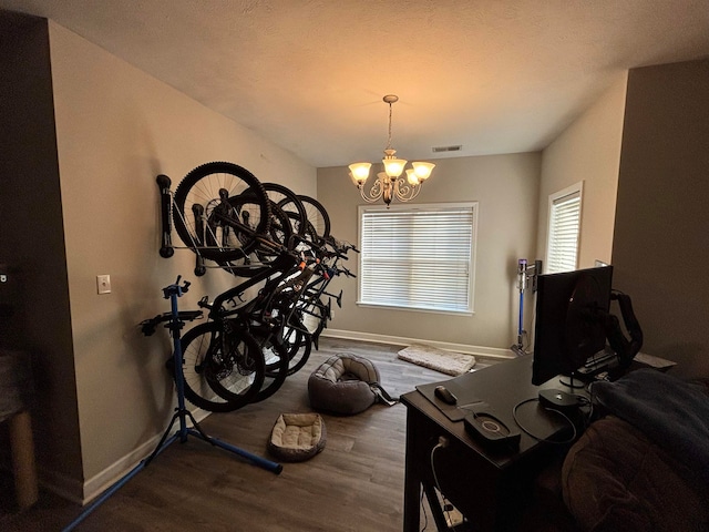 interior space featuring an inviting chandelier, visible vents, baseboards, and dark wood finished floors