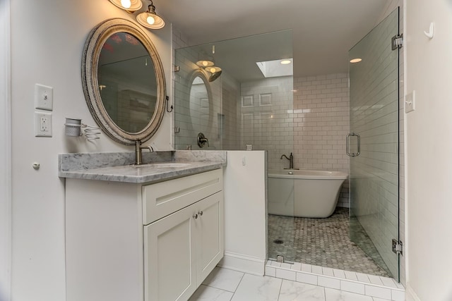 bathroom featuring vanity, shower with separate bathtub, and a skylight