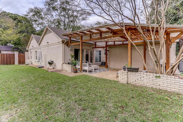 back of property with a pergola, a yard, and a patio area