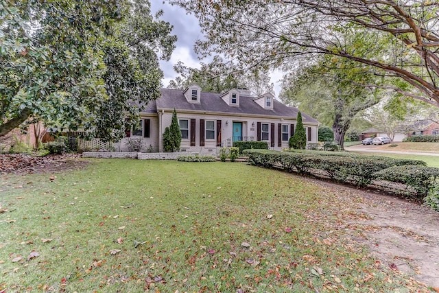 cape cod house with a front lawn