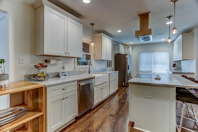 kitchen featuring white cabinetry, hanging light fixtures, dark hardwood / wood-style floors, and stainless steel appliances