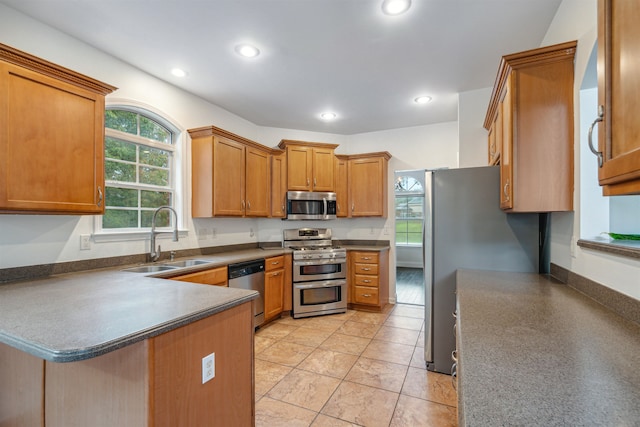 kitchen featuring light tile patterned flooring, sink, and appliances with stainless steel finishes