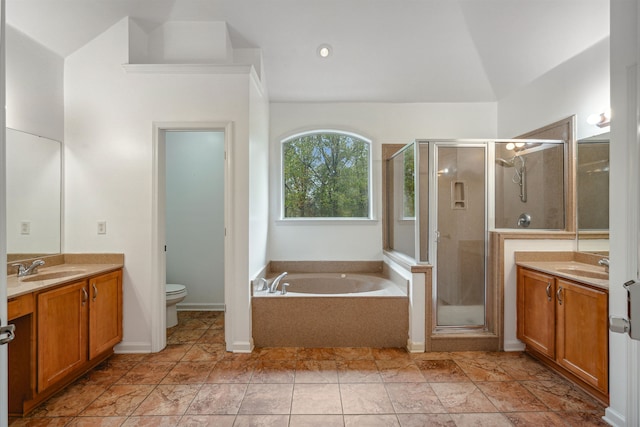 full bathroom with toilet, vanity, lofted ceiling, and shower with separate bathtub