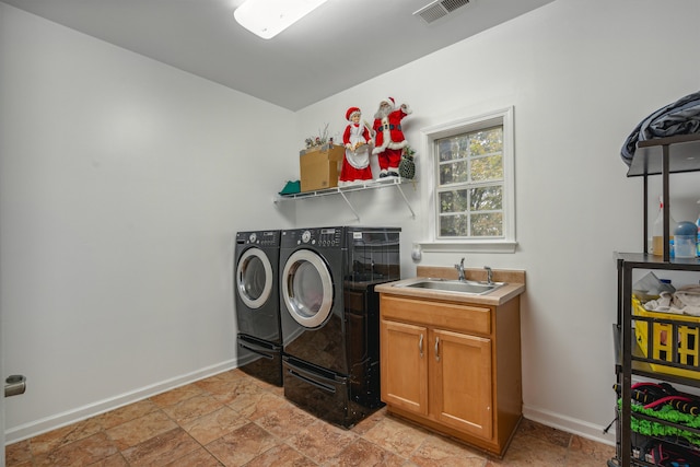 laundry room with cabinets, sink, and washing machine and clothes dryer