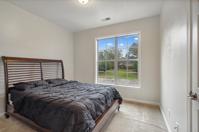 bedroom featuring light colored carpet