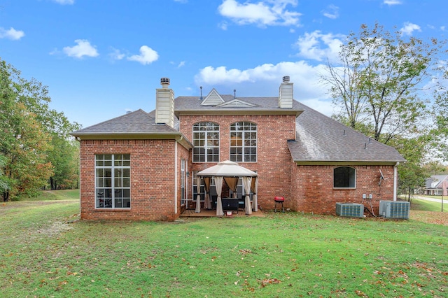 rear view of property featuring central AC and a yard