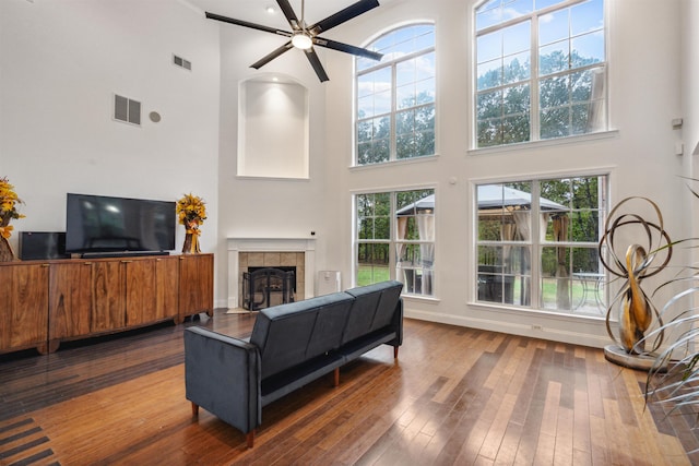 living room with plenty of natural light, hardwood / wood-style flooring, and a high ceiling