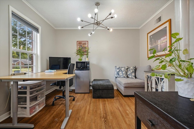 office featuring a chandelier, hardwood / wood-style floors, ornamental molding, and a textured ceiling