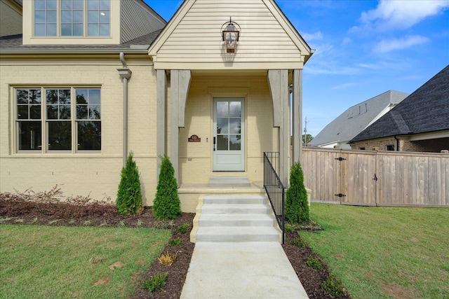 entrance to property featuring a lawn