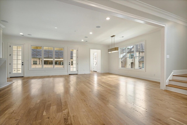 unfurnished living room with ornamental molding and light hardwood / wood-style flooring