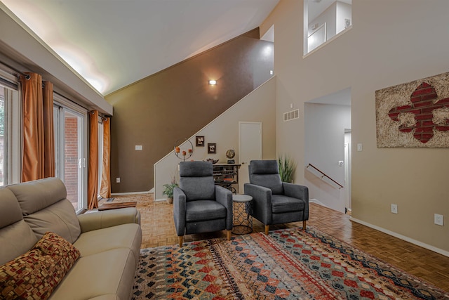 living room with high vaulted ceiling and parquet floors