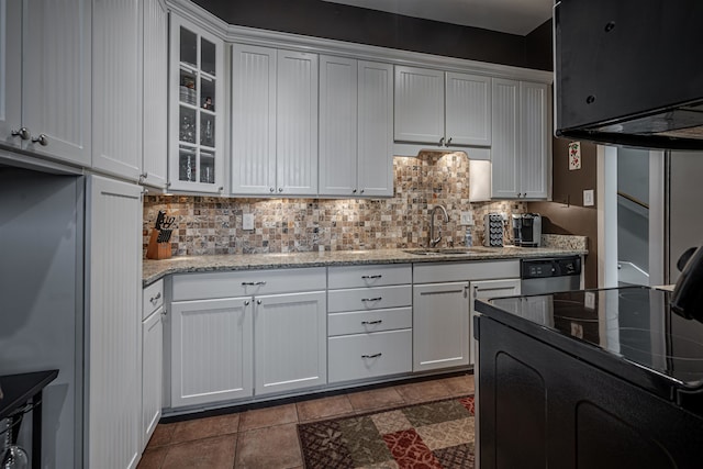 kitchen featuring white cabinetry, sink, and light stone counters