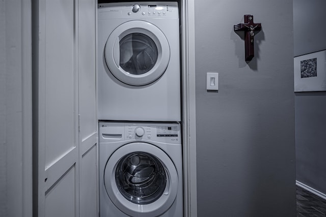 clothes washing area featuring stacked washer / drying machine