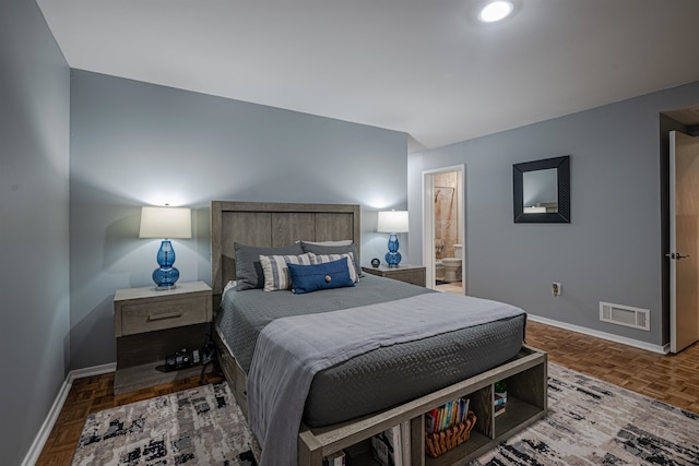 bedroom with parquet flooring and ensuite bath