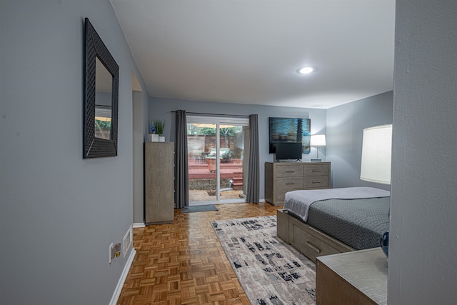 bedroom with dark parquet floors and access to outside