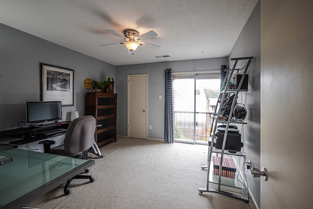 office area featuring carpet floors, a textured ceiling, and ceiling fan