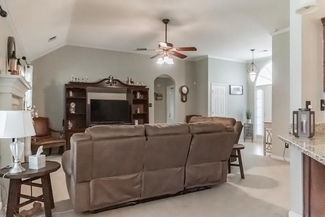 living room with ceiling fan, crown molding, and vaulted ceiling