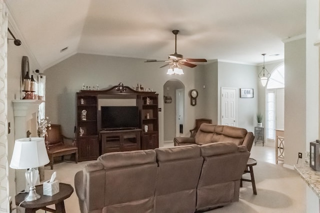 living room with vaulted ceiling, ceiling fan, crown molding, and light colored carpet