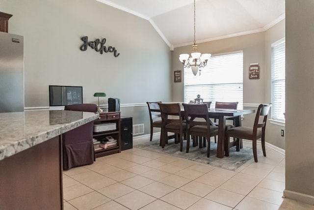 tiled dining room with a chandelier, lofted ceiling, and ornamental molding