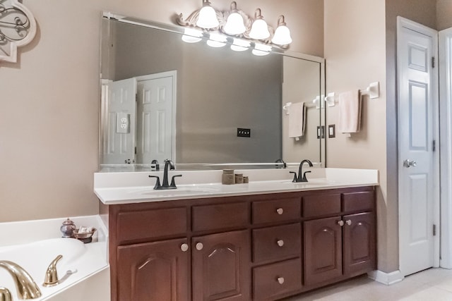 bathroom with a washtub, vanity, and tile patterned flooring