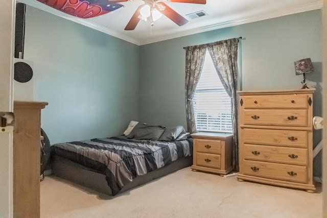 carpeted bedroom featuring ornamental molding and ceiling fan