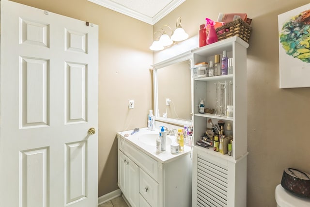 bathroom with toilet, vanity, and crown molding