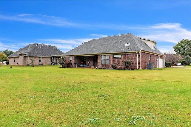 rear view of house featuring a patio, a yard, and cooling unit