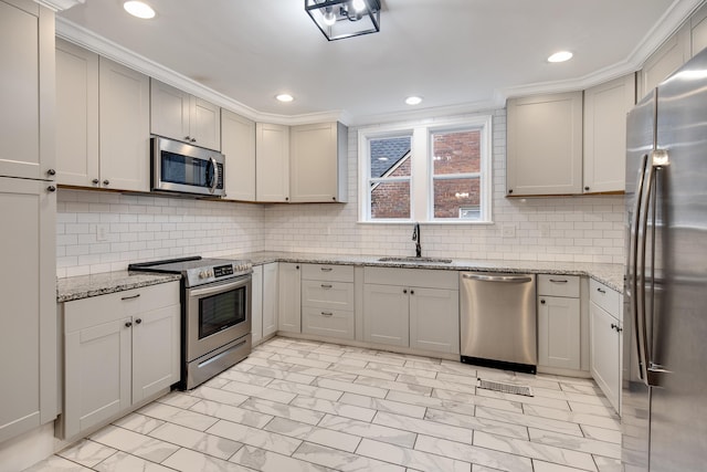 kitchen featuring sink, ornamental molding, stainless steel appliances, light stone countertops, and backsplash