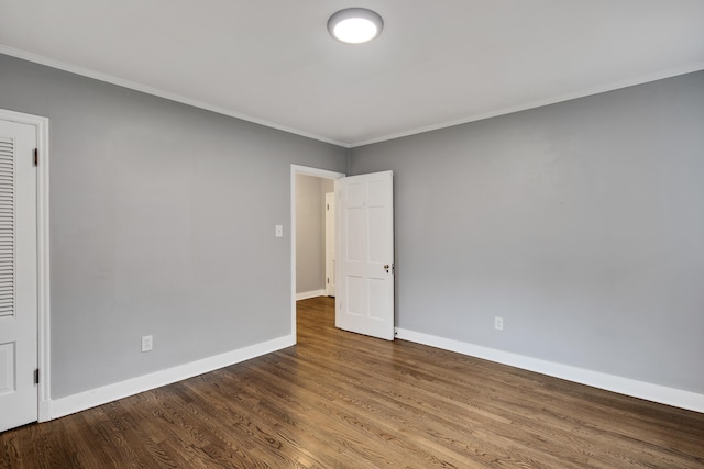 spare room with hardwood / wood-style flooring and ornamental molding