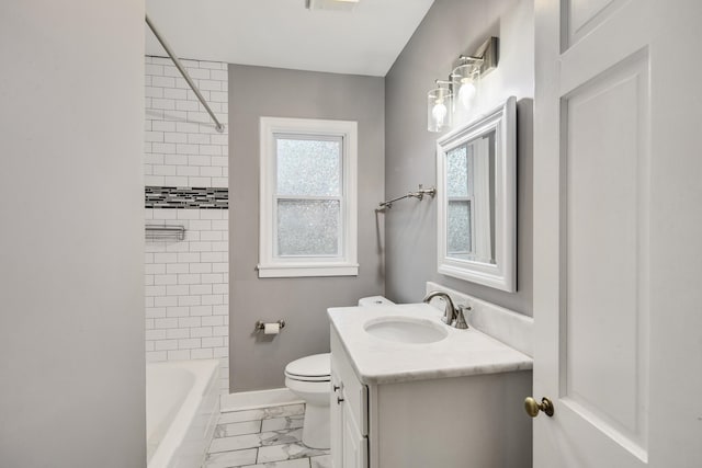 full bathroom featuring tiled shower / bath, vanity, and toilet