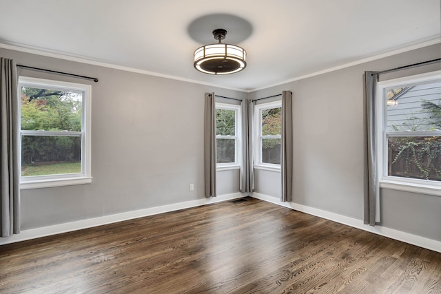 unfurnished room with ornamental molding, plenty of natural light, and dark hardwood / wood-style flooring