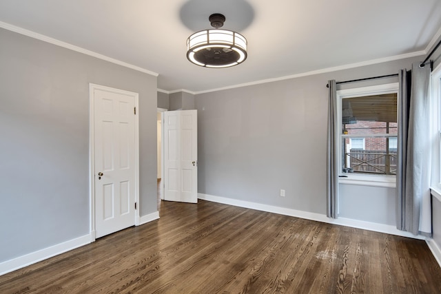 unfurnished room with ornamental molding and dark hardwood / wood-style floors