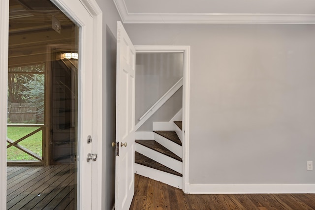 staircase with wood-type flooring and ornamental molding