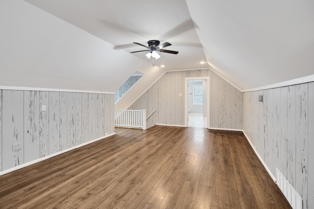 bonus room with ceiling fan, lofted ceiling, and dark hardwood / wood-style flooring