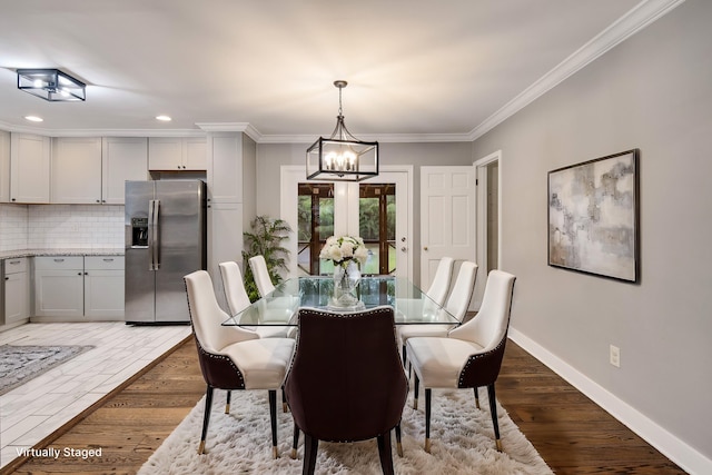 dining area featuring ornamental molding, dark hardwood / wood-style floors, and an inviting chandelier