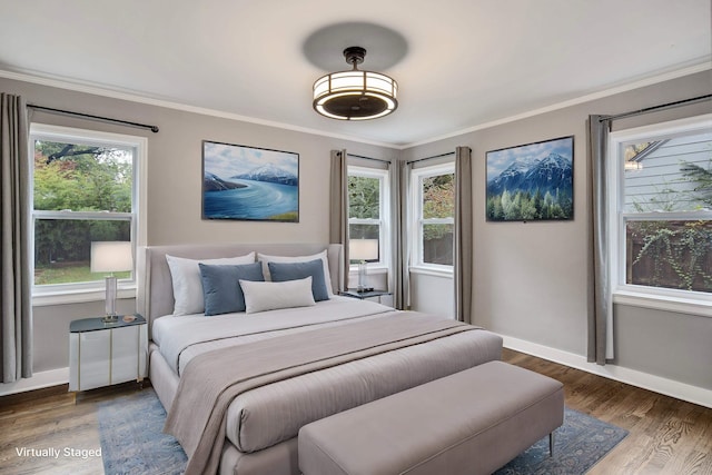 bedroom with crown molding, dark wood-type flooring, and multiple windows