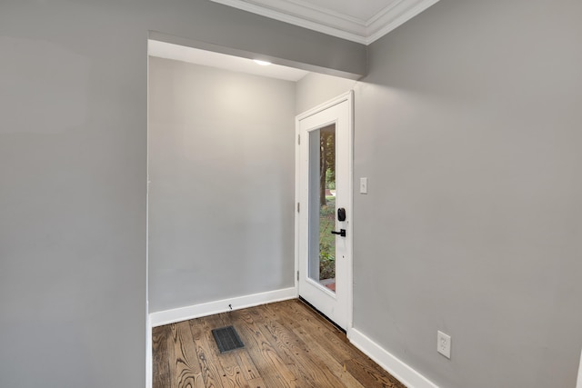 entryway featuring wood-type flooring and ornamental molding