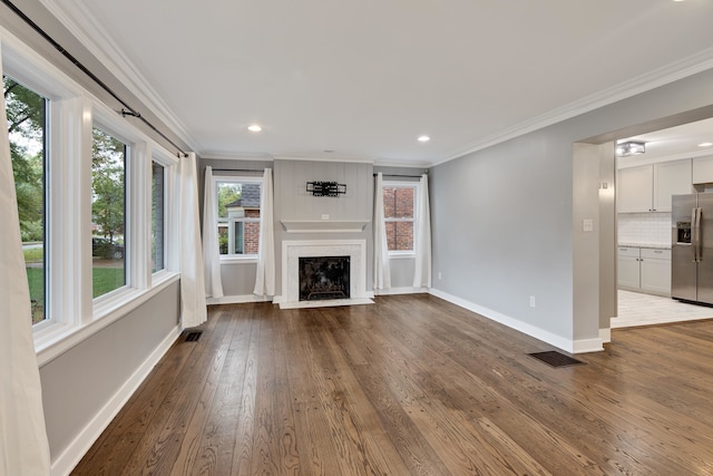 unfurnished living room with crown molding, hardwood / wood-style floors, and a high end fireplace