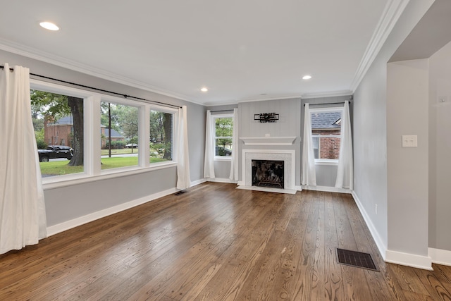 unfurnished living room featuring ornamental molding, wood-type flooring, and a fireplace