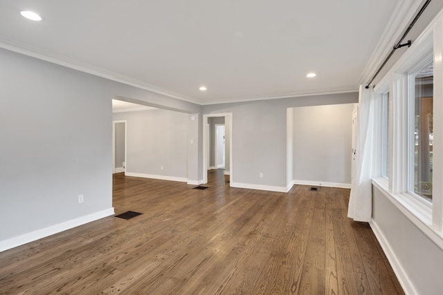 empty room with dark wood-type flooring and crown molding