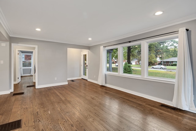 spare room featuring crown molding and hardwood / wood-style flooring