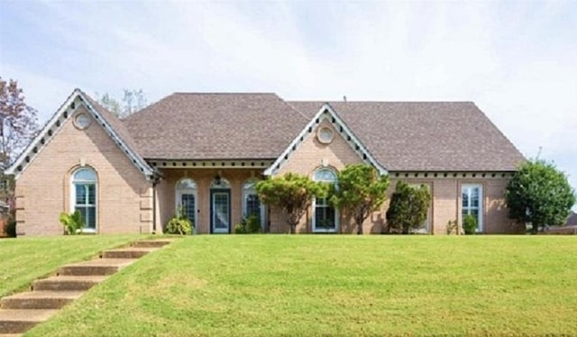 tudor-style house with a front lawn