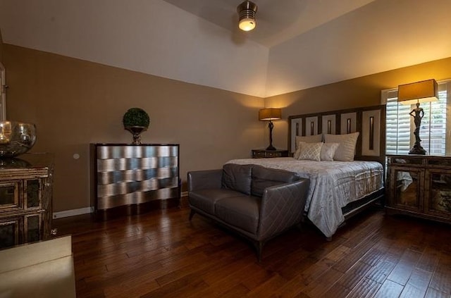 bedroom with dark hardwood / wood-style flooring, lofted ceiling, and ceiling fan