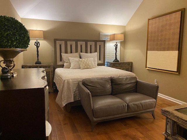 bedroom featuring hardwood / wood-style floors and vaulted ceiling