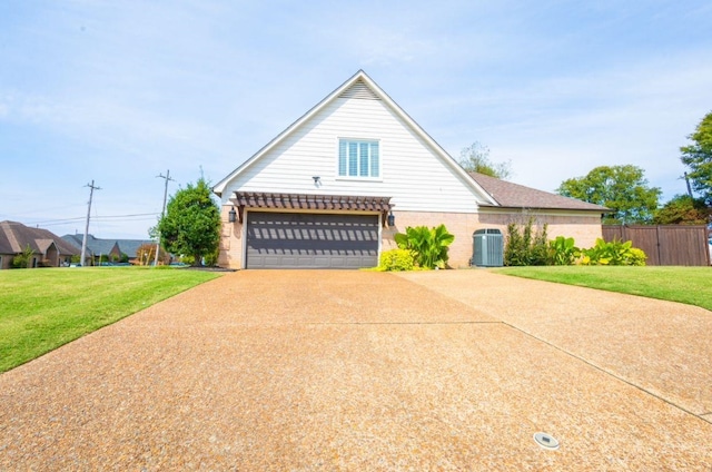 view of front of house featuring a front lawn, a garage, and cooling unit