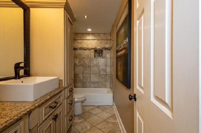 full bathroom with vanity, tile patterned flooring, toilet, and tiled shower / bath combo