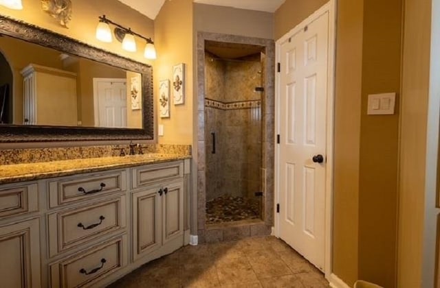 bathroom with vanity, an enclosed shower, and tile patterned flooring